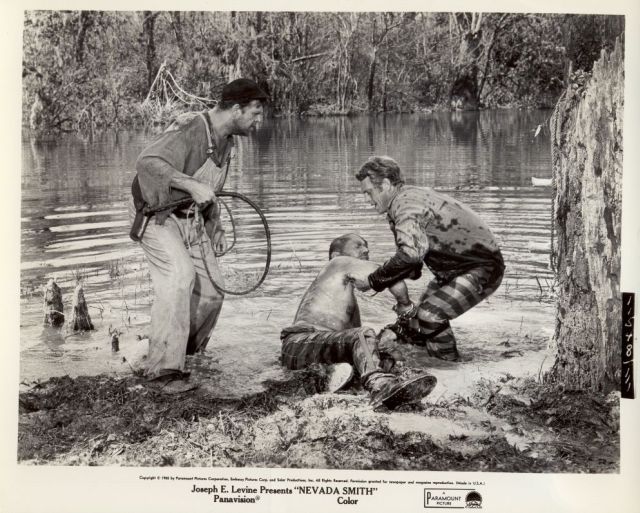 Max (McQueen) pulls 
Bill Bowdrie (Arthur Kennedy) from the swamp, as 
Big Foot (Pat Hingle) watches on.